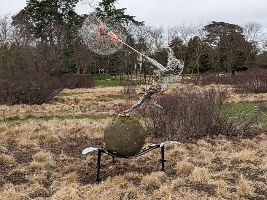 Wire fairy and dandelion sculpture in winter gardens