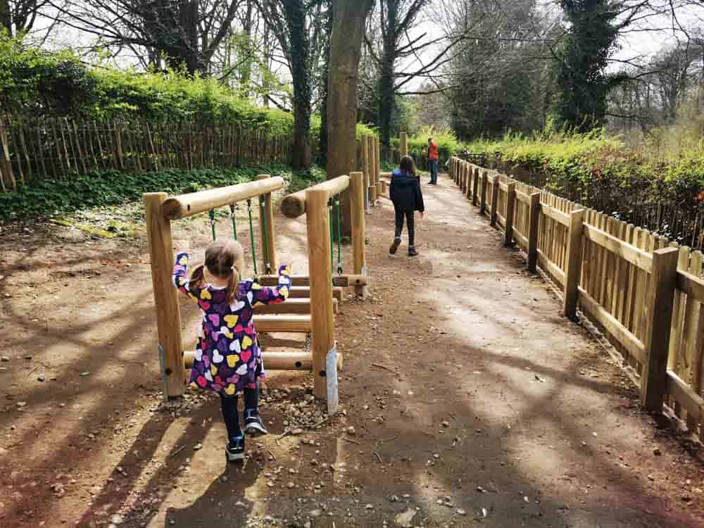 Child on wooden assult course play area