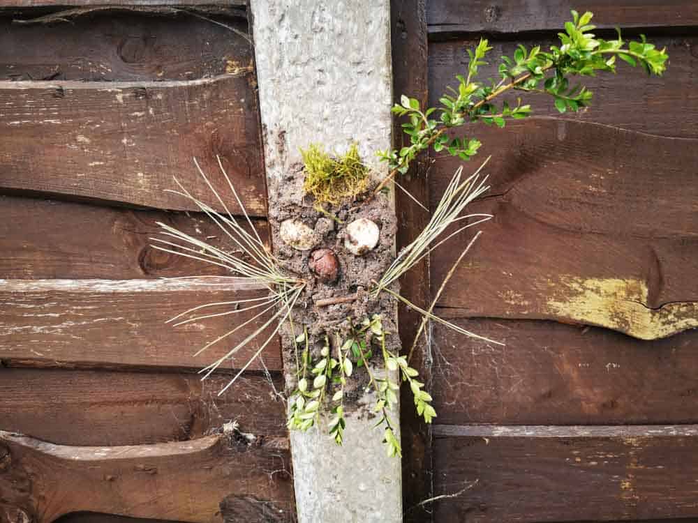 Clay face on a fence post