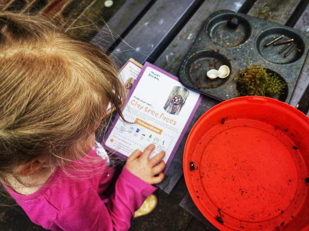 Child preparing to make mud faces