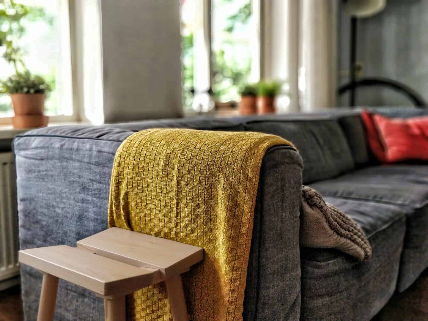 Modern sofa with yellow throw