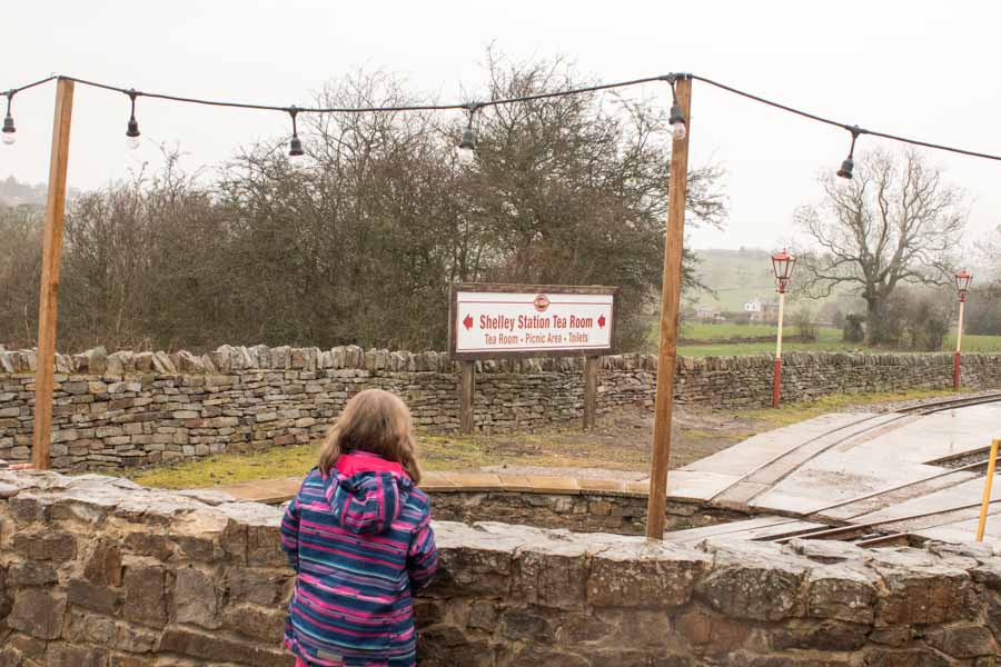 girl looking at a sign at Shelly station
