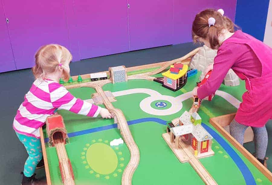 two children playing with train set