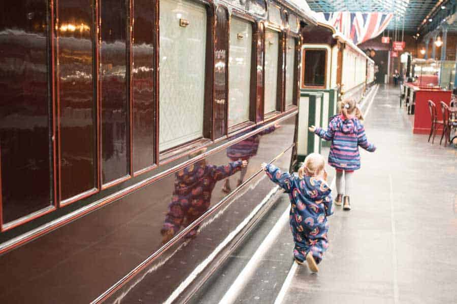 two children next to a traditional train