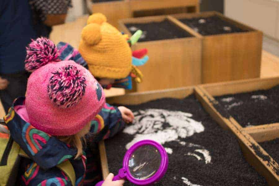 Children looking for fossils in fake mud at Yorkshire museum