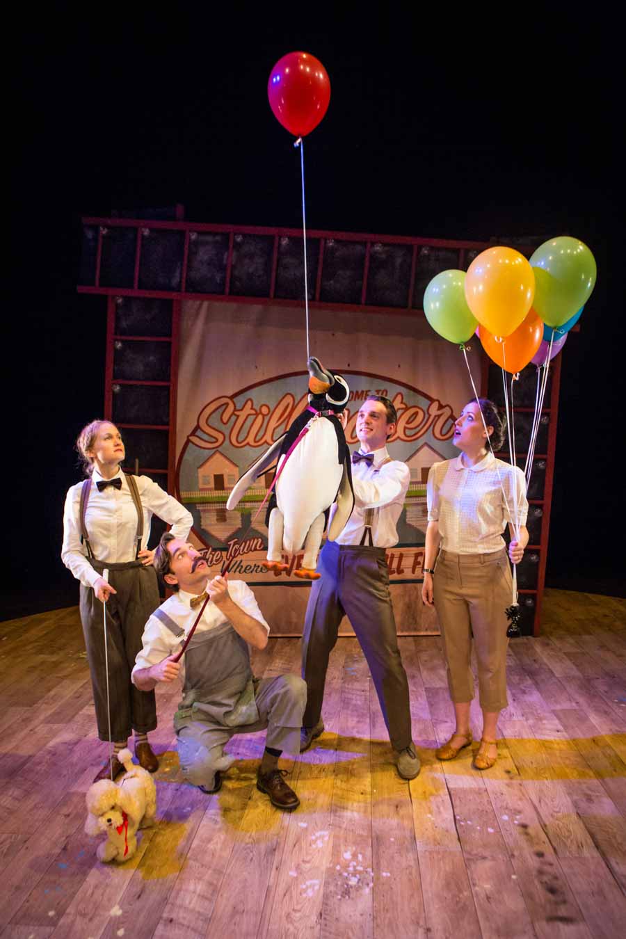 Cast of Mr Popper's penguins on stage with puppet penguin ans balloons