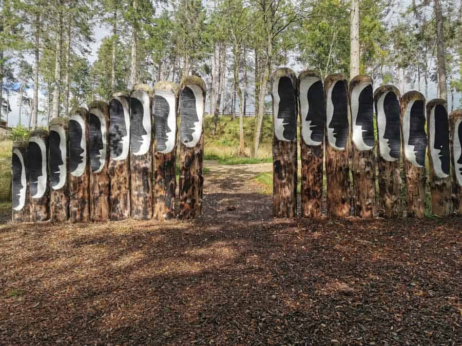 large wooden sculpture in the woods