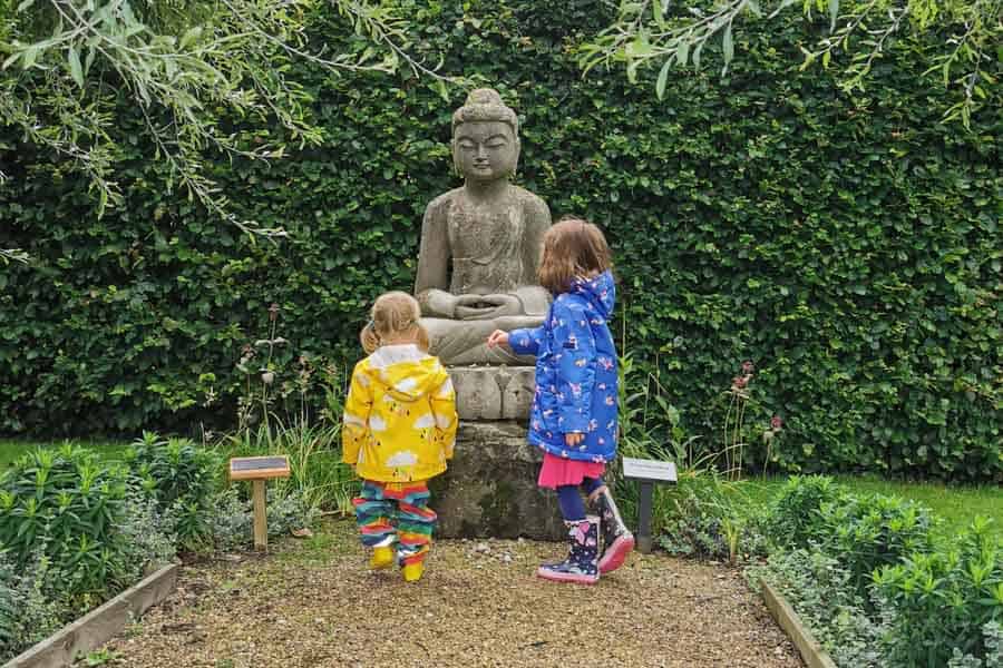 Children with a large stone Buddha statue
