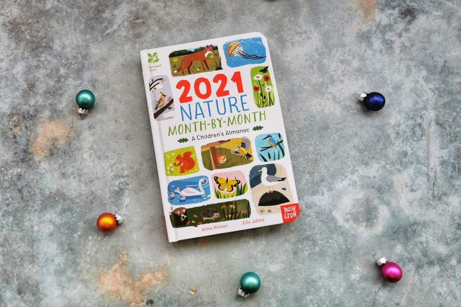 2021 children's almanac book on a stone background surrounded by mini baubles