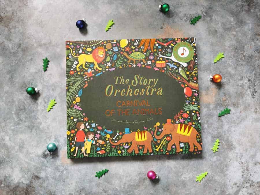 Front cover of the book thestory orchestra on a stone background with mini christmas decorations