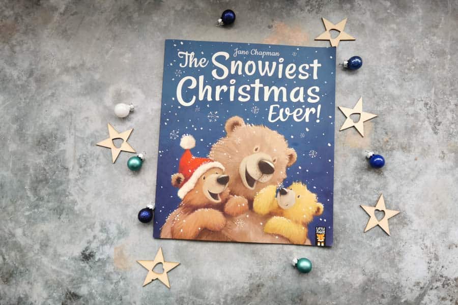 Copy of the snowiest Christmas ever, childrens book on a stone background with mini christmas decorations surrounding it