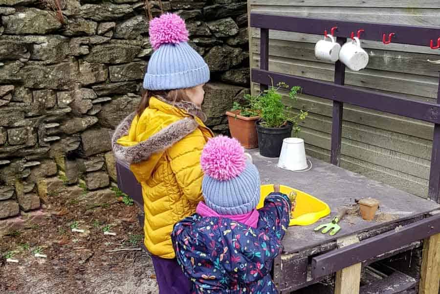 children playing in a mud kitchen