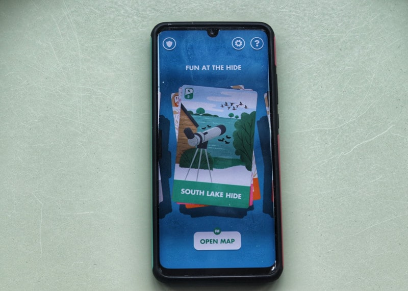 Phone with wetland heroes app cards