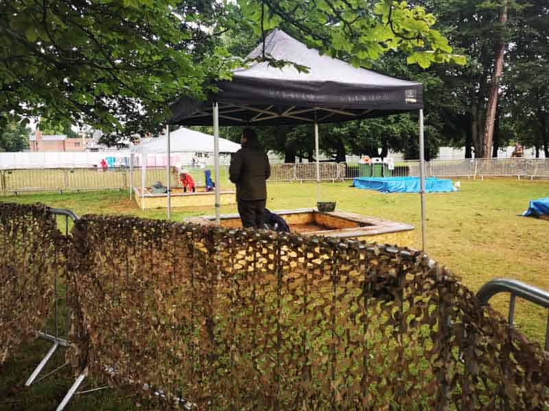 Two sandpits with gazebos over them in the rain