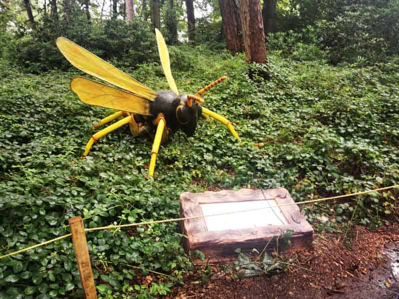 Large bee sculpture in the woods