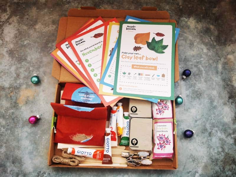 box filled with items like clay, paitn and twine