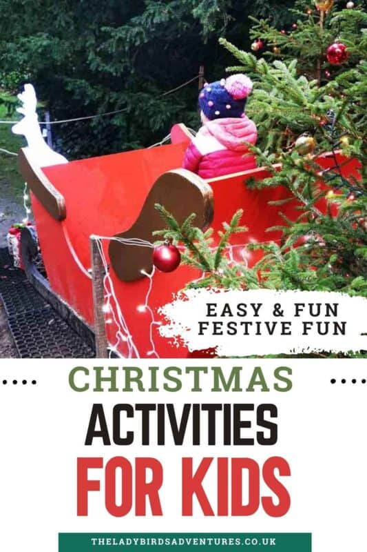 Child in a pink coat and pom-pom hat sitting in a red Christmas sleigh next to a decorated tree with baubles and lights, with text reading ‘Christmas Activities for Kids – Easy & Fun Festive Fun.’