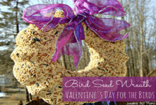 Wreath made of bird seeds with large purple bow.