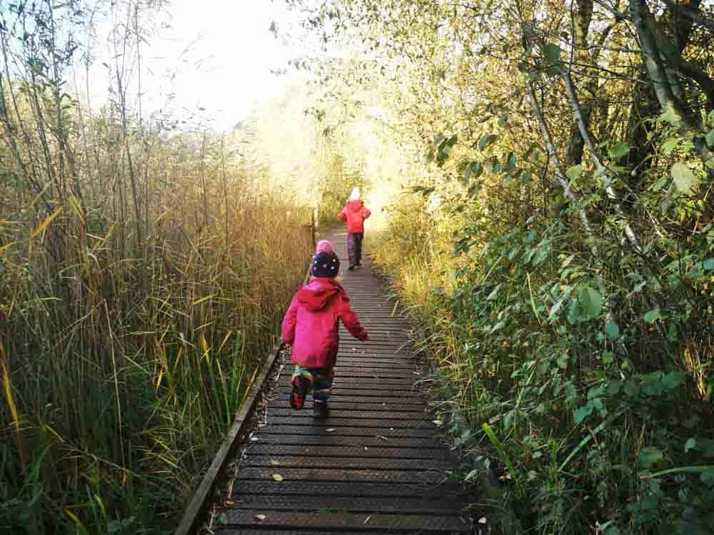 Children running along board walk