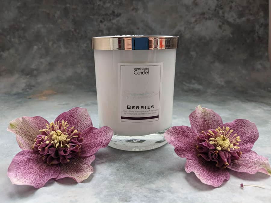 Glass jar white candle and flowers
