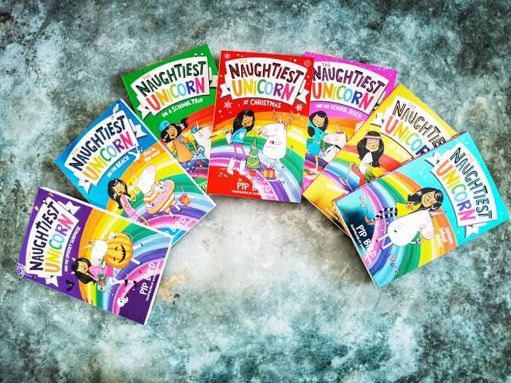 Fanned out collection of 7 Naughtest unicorn books