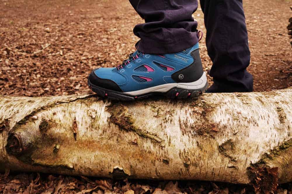 Blue walking boot stood on a log