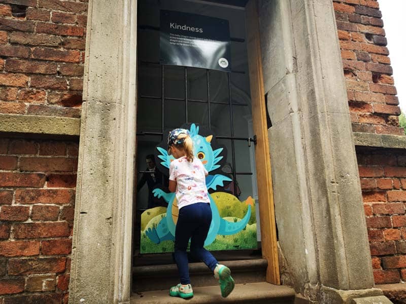 Child in front of a dragon sign