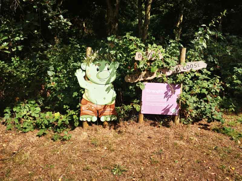 Troll sign in a hedge