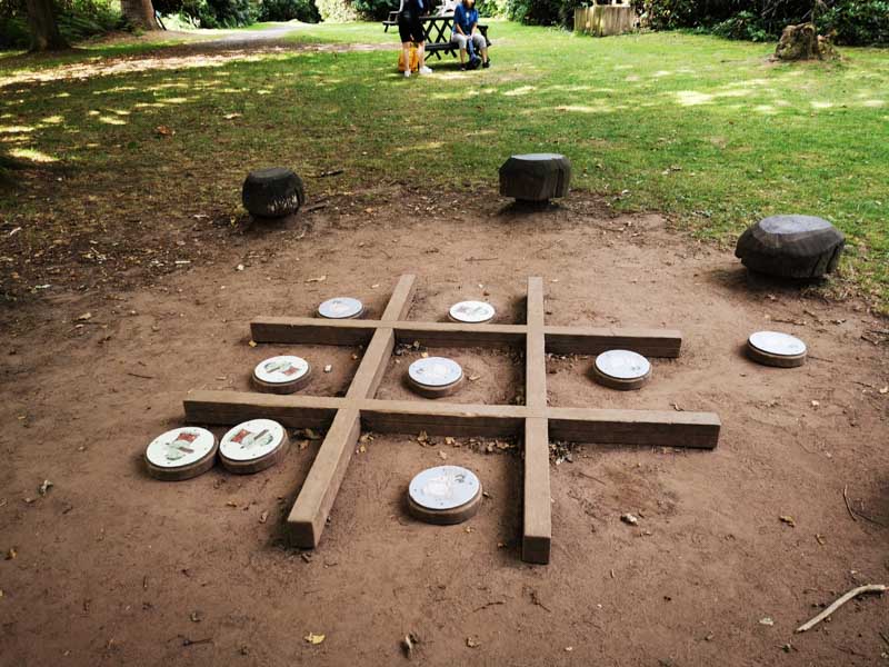 large wooden naughts and crosses board on the ground