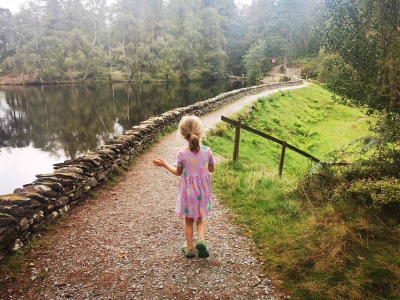 Child on path next to a lake