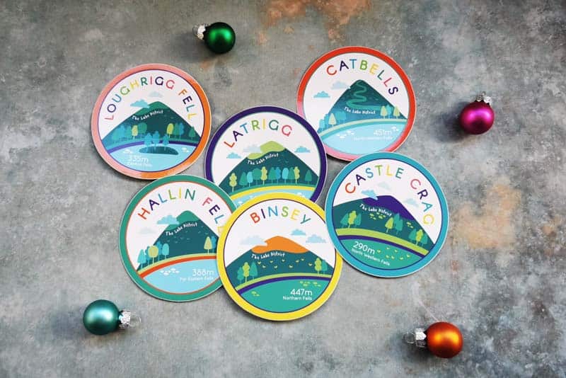 6 round stickers with different lake district fells illustrated on them