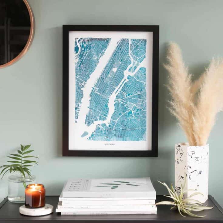 City map in blue, in a black frame on a wall