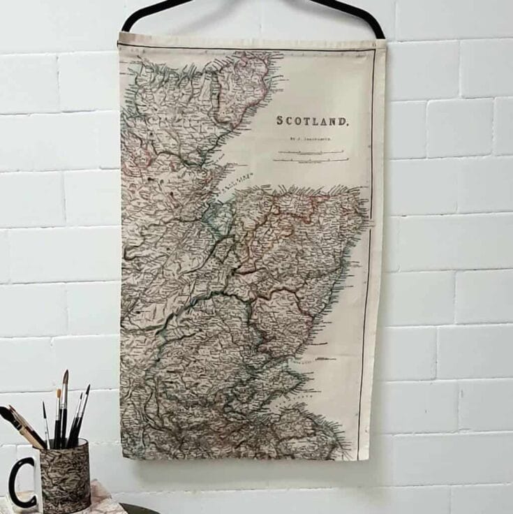 Tea towel hung up displaying a vintage map of Scotland
