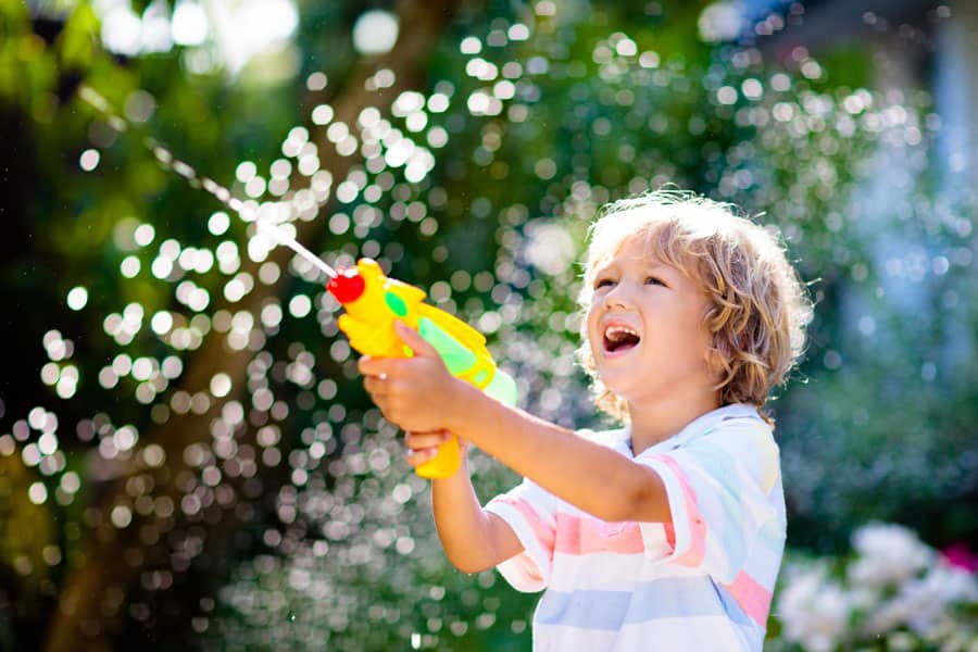Toddler boy with a water gun