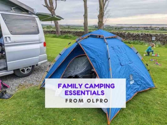 Small tent next to a campervan. Text says family camping essentials from OLPRO
