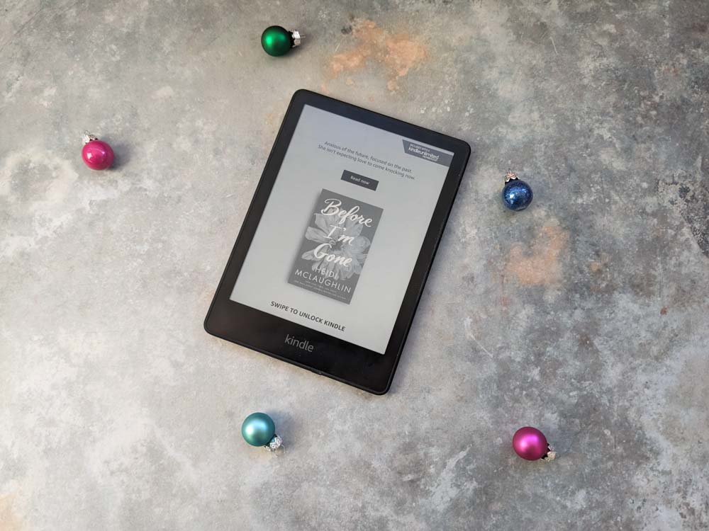 Kindle on a stone surface surrounded by mini baubles
