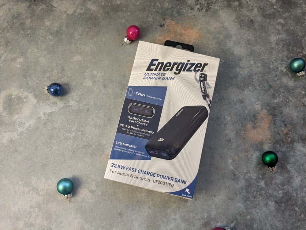 Boxed powerbank on a stone surface surrounded by mini baubles
