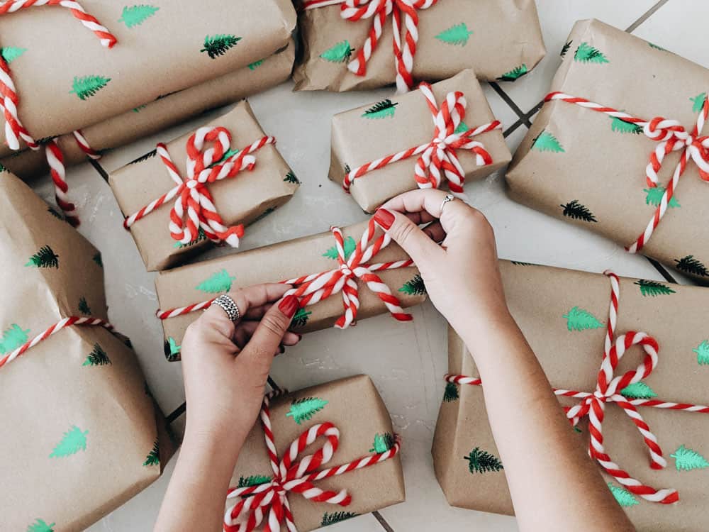 Lots of brown paper presents wrapped and tied with red twine