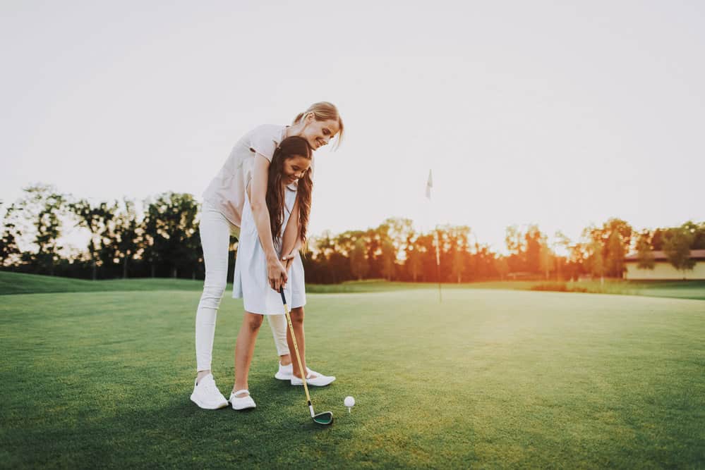 Mum and daughter playing golf