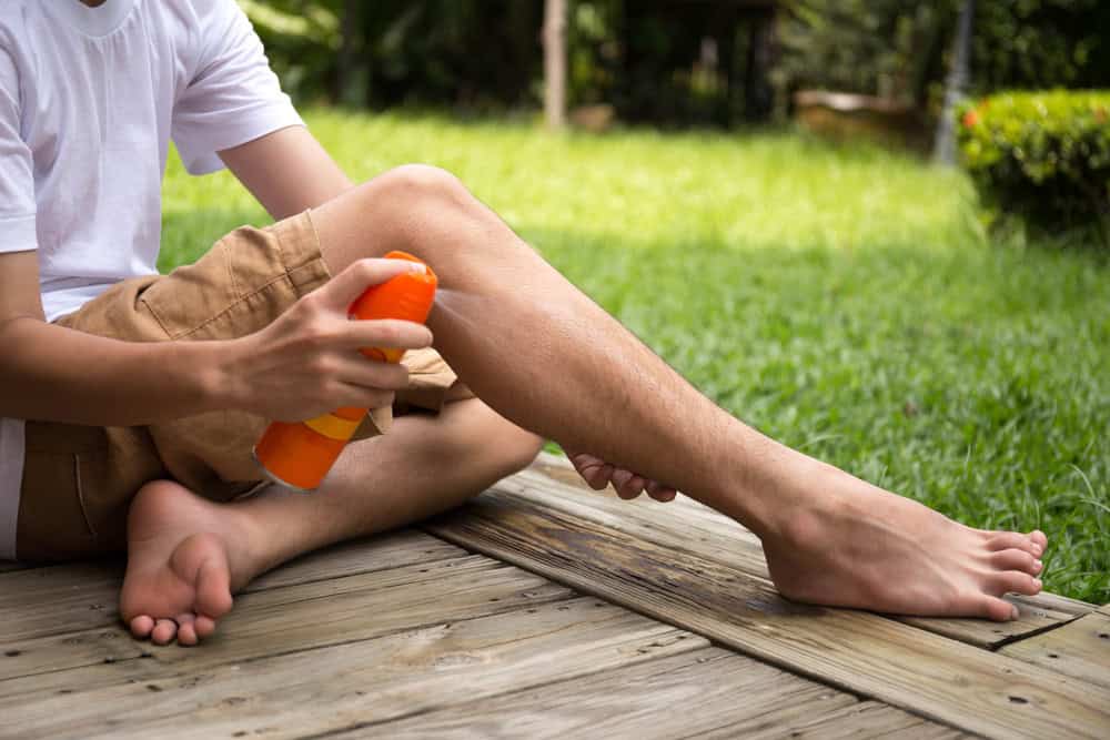 Man applying insect repellant