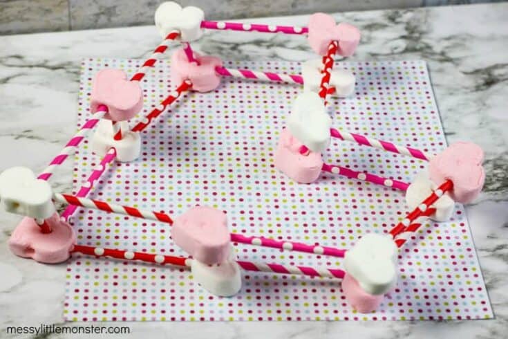 A heart shape made of marshmallows and red and white paper straws