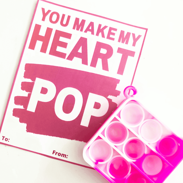 Pink and white popper and a card that says you make my heart pop
