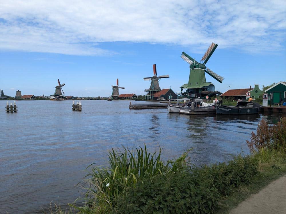 Lake with lots of traditional green wooden windmills alongside