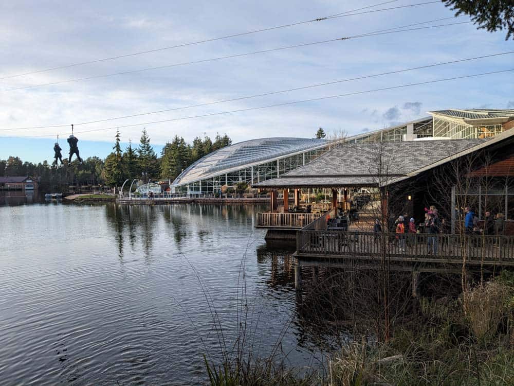 Lake with a large building next to it with huge glass domed roof