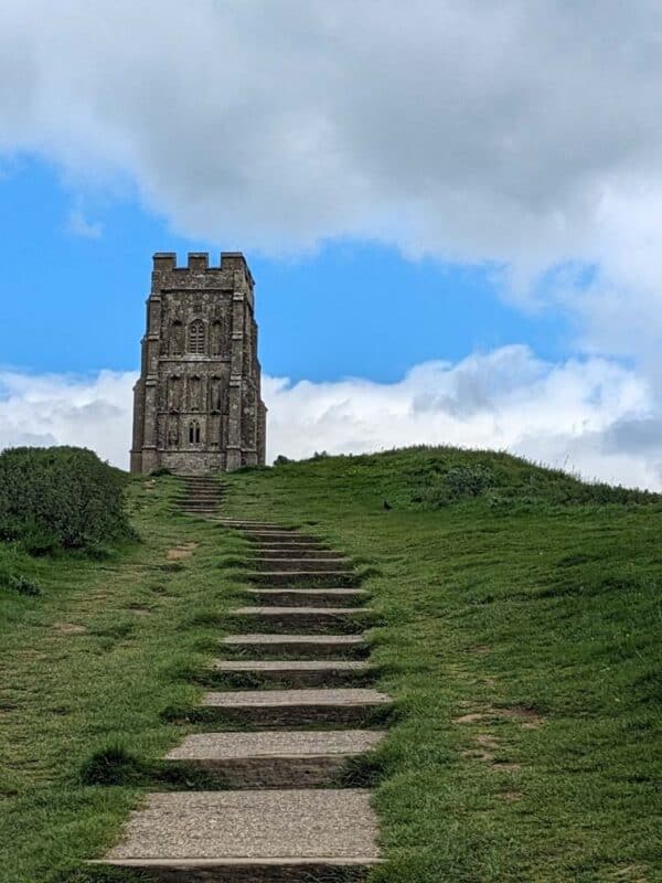 Small castle on a hill with steps leading to it