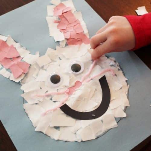 Little hand sticking paper on a bunny picture