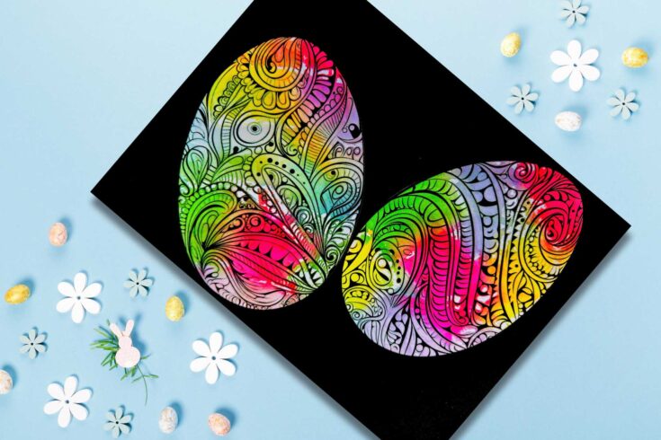 Black card with two colourful patterned eggs on