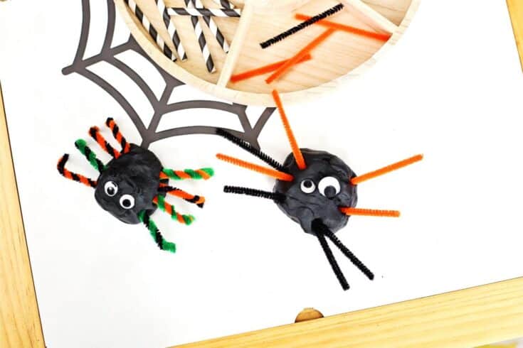 Two spiders made of playdough and pipe cleaners