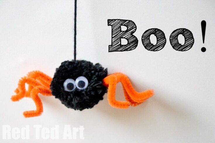 Black pom pom with eyes and orange pipe cleaner legs