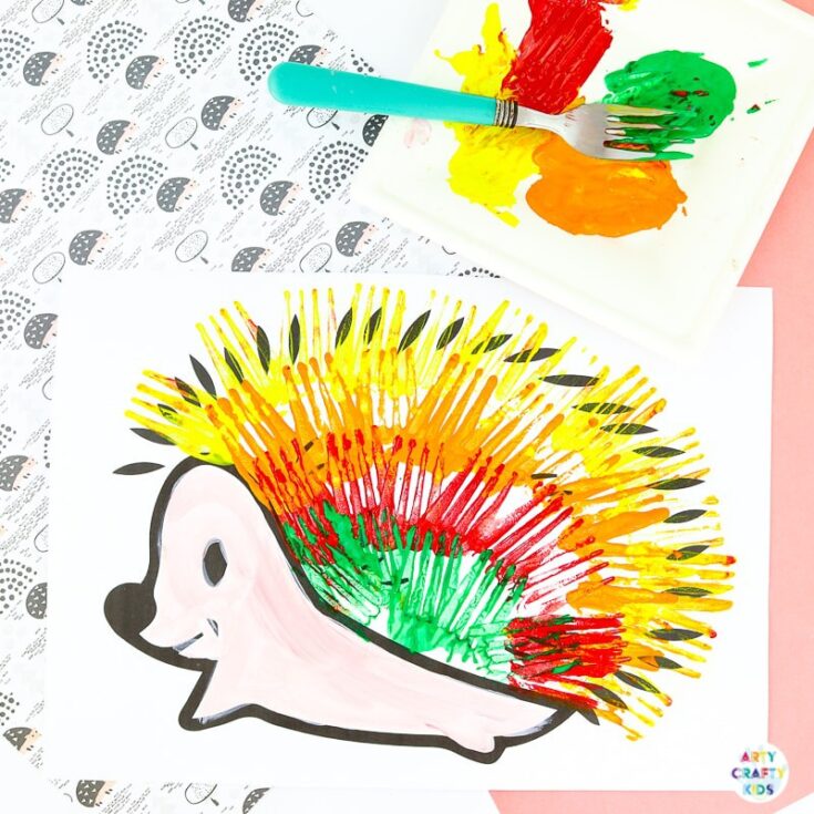 Fork painted hedgehog craft for kids with colorful red, yellow, and green painted spikes on paper.